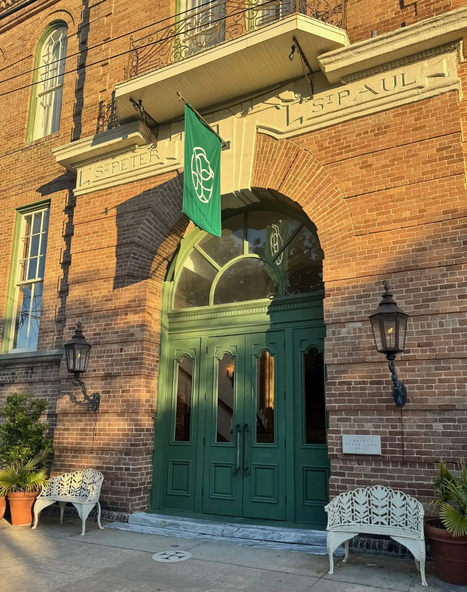 Exterior entrance of Hotel Peter & Paul in New Orleans with historic St. Peter & St. Paul church signage
