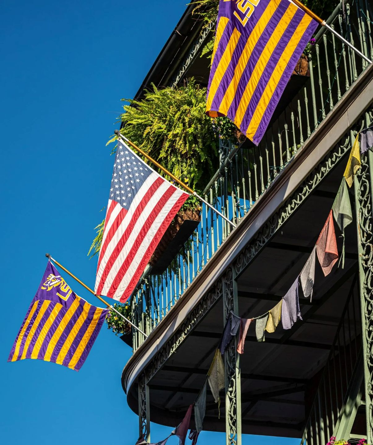 New Orleans French Quarter balcony with flags - 30 Days 30 Boutique Hotel Stays