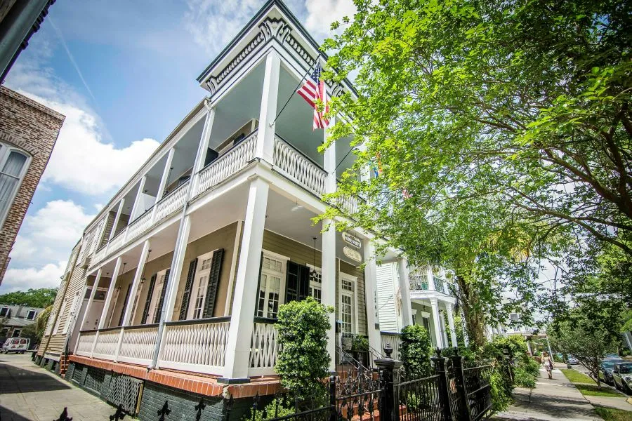 Rathbone Mansions Hotel exterior showing two-story wrap-around balconies on Esplanade Avenue in the Treme neighborhood