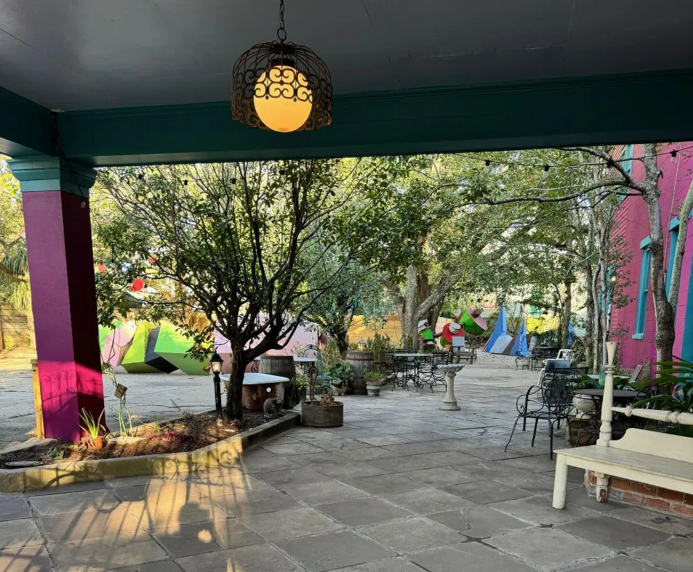 Courtyard at Hotel Pompadour in New Orleans with sculptures and garden lanterns