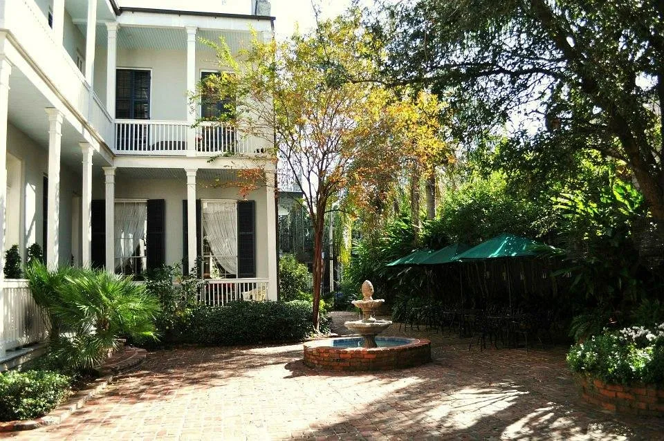 Brick courtyard with fountain at the Terrell House boutique hotel in New Orleans Lower Garden District